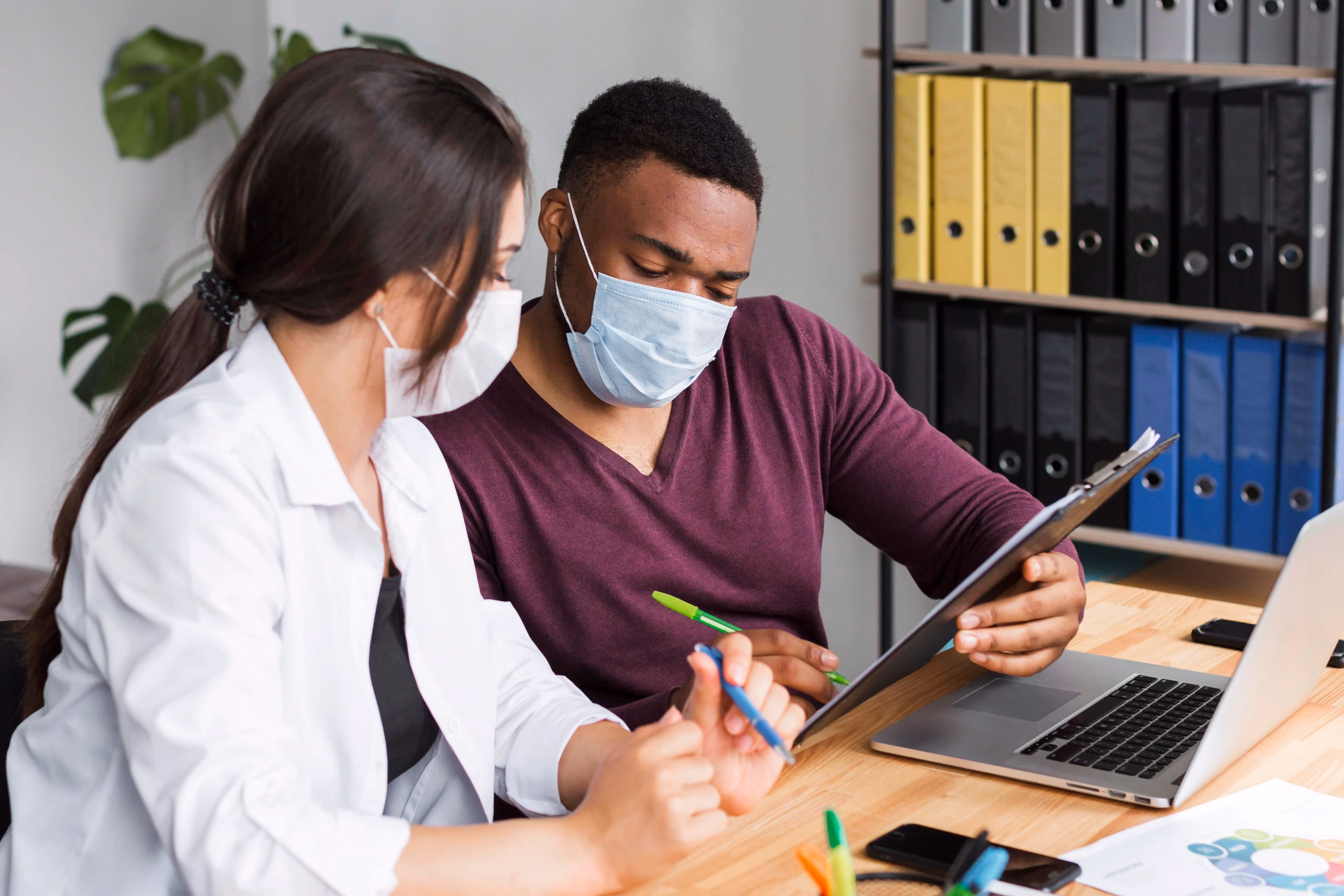 Doctor reviewing financial documents and tax paperwork at medical practice desk